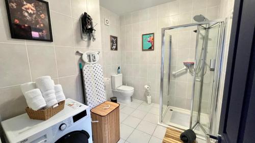 a bathroom with a shower and a toilet at Rest Boutique Golders Green in London