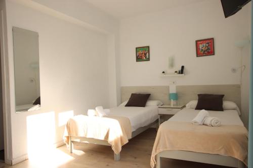 a bedroom with two beds and a mirror at Hotel Boogaloo - Adults Only in El Arenal