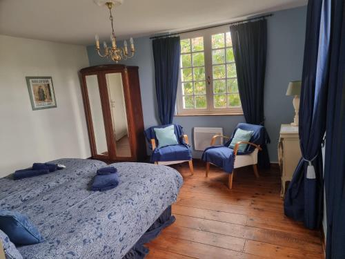 - une chambre avec 2 lits et 2 chaises bleues dans l'établissement Large country house, private pool & large garden, à Bergouey