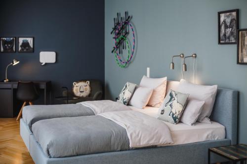 a bedroom with a bed with pillows on it at The Circus Apartments in Berlin