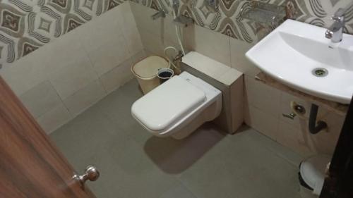 a bathroom with a toilet and a sink at Terminus Square in Kurla