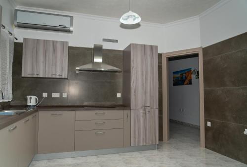 a kitchen with a sink and a stove at Sea-View Studio Apartment - Sleeps 2 in Marsaskala