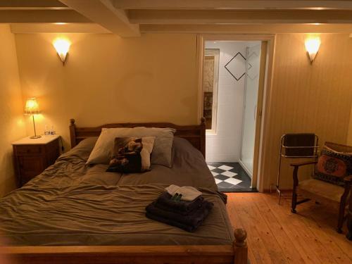 a bedroom with a bed with a dog laying on it at B&B Petit Chateau - Stijlvol verblijf Centraal gelegen in Zeeuws Vlaanderen in Biervliet