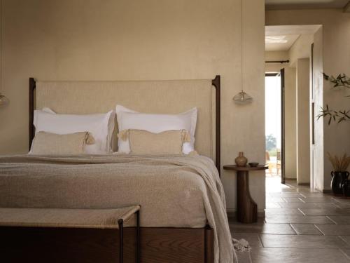 a bedroom with a large bed with white pillows at Pierros Verde in Lithakia