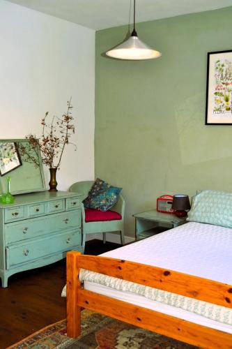 une chambre avec un lit et une commode dans l'établissement Gite Esmeralda, à Biert