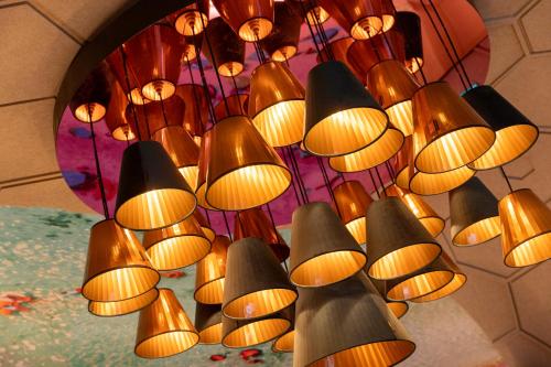 a bunch of lights hanging from a ceiling at Mister Highland Hotel in Amsterdam