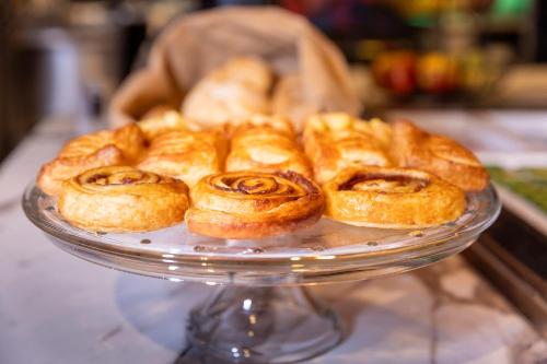 a glass plate with croissants on a table at Mister Highland Hotel in Amsterdam