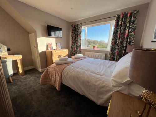 a bedroom with a bed with two towels on it at Brian’s Escape in Great Driffield