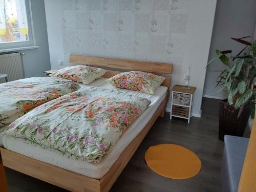 a bedroom with two beds with floral bedding at Fewo Rosi in Brotterode