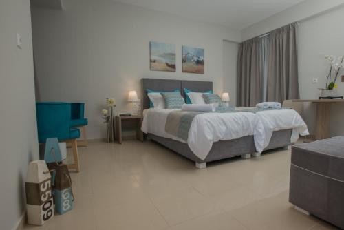 a bedroom with a king sized bed and a desk at Athina Residence in Léntas