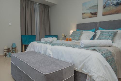 a bedroom with two beds and a table between them at Athina Residence in Léntas