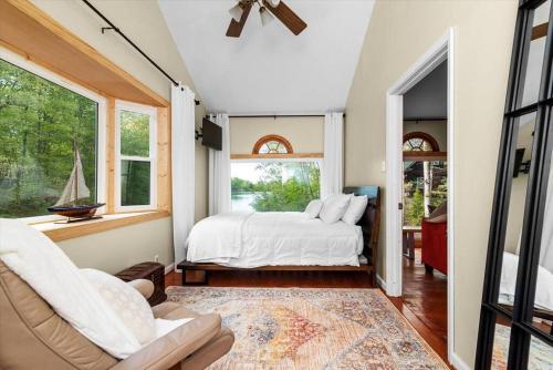 a bedroom with a bed and a large window at King Suites, Lakefront, Hot Tub, Watercraft in Harpers Ferry