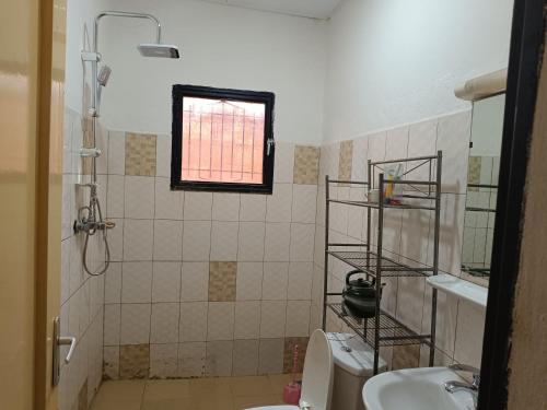 a bathroom with a shower and a toilet and a sink at AKD Résidence et Automobile in Ouagadougou