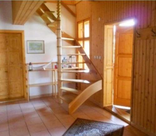 a room with a spiral staircase in a house at Penzion Hron in Brezno