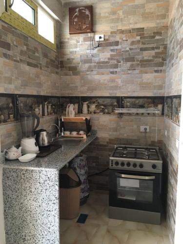a kitchen with a stove and a counter top at Villamar Sea View rooms & apartments in Hurghada