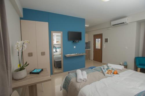 a room with a bed and a blue wall at Athina Residence in Léntas