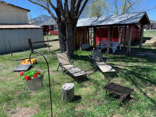 a yard with benches and a table and a tree at Grand Canyon Ranch Home - Western History - Big city lot - AC! in Williams
