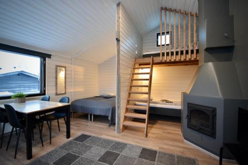 a tiny house with a staircase and a bedroom at Aava Sky Village Aurinkomaja in Aavasaksa