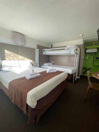 a hotel room with two beds and a table at Campanile Troyes Sud - Buchères in Troyes