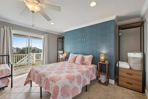 a bedroom with a bed and a balcony at Bird's Nest in Holden Beach