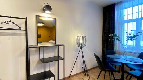 a dining room with a table and a mirror at Kastani Factory Apartments in Tartu