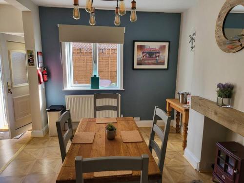 a dining room with a wooden table and chairs at Sunbeams and ice creams in Scarborough