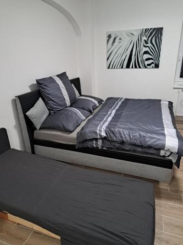 a bed sitting in a room with a zebra picture on the wall at Penzion Labužník in Lovosice
