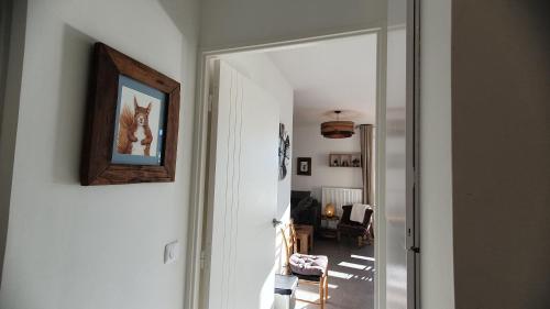 a hallway with a picture of a dog on the wall at T3 STANDING CENTRE STATION VALBERG in Valberg
