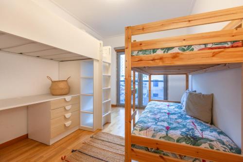 a bedroom with two bunk beds and a closet at Apartamento Lisboa Sete Rios in Lisbon
