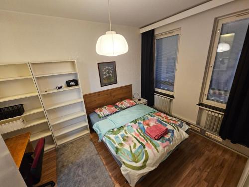 a small bedroom with a bed and shelves at Top floor at heart of Tampere for 4 person in Tampere