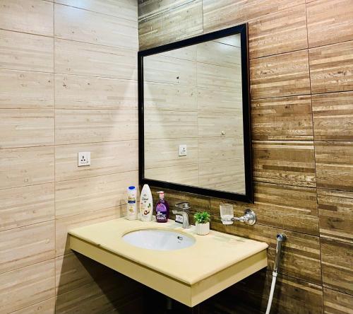 a bathroom with a sink and a mirror at Executive one bedroom apartment in bahria hieghts in Rawalpindi