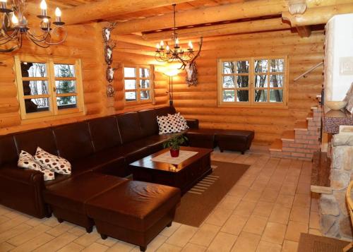 a living room with a couch and a table at Luxury Chalet at Podlipje Estate in Tešanovci