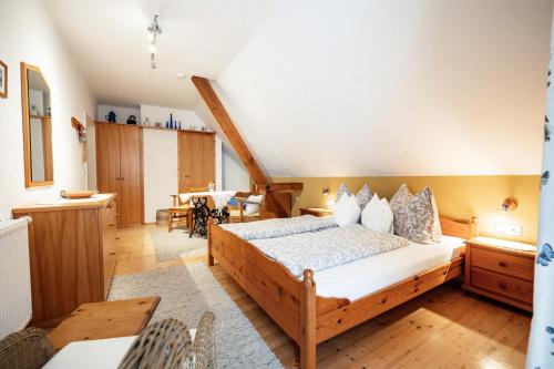 a bedroom with a bed and a dining room at Winzerzimmer Pronegg vlg. Kristeindl in Leutschach