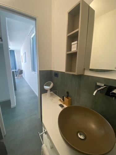 a bathroom with a green sink and a mirror at Marina Bay Beach Hotel in Peschici