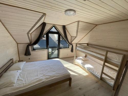 a bedroom with a bed in a room with windows at Amelia Resort in Sianozety