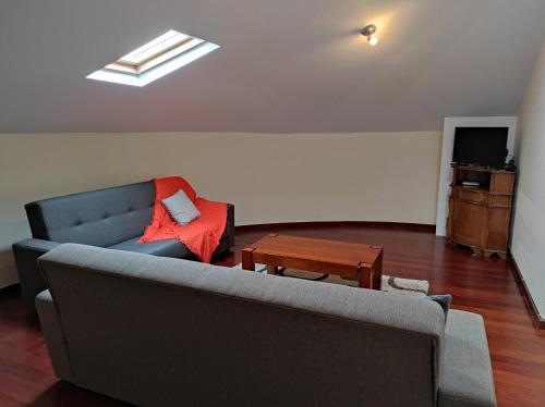 a living room with a couch and a table at Casa Câmara in Arco da Calheta
