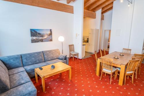 a living room with a couch and a table at alpsrental Apartments Freja Obertauern in Obertauern