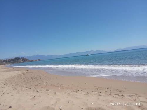 a sandy beach with the ocean in the background at Sea melodies apartment 1 in Koroni