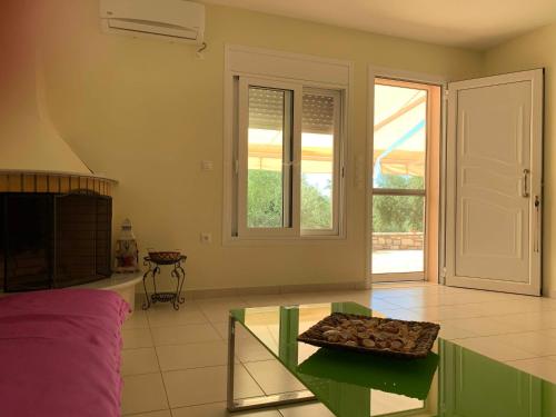 a living room with a glass table and a window at Sea melodies apartment 1 in Koroni