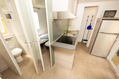 a small bathroom with a sink and a toilet at Camping Bellsol Pets in Pineda de Mar