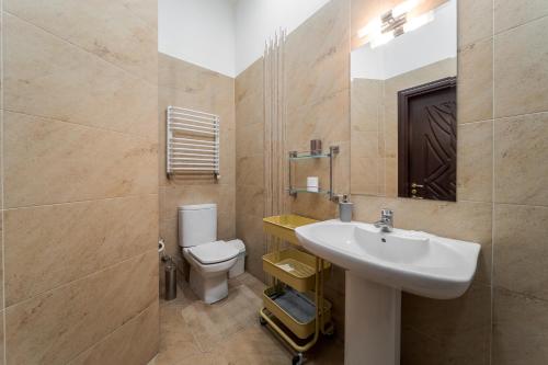 a bathroom with a sink and a toilet at Апартаменти на Площі Ринок, 20 in Lviv