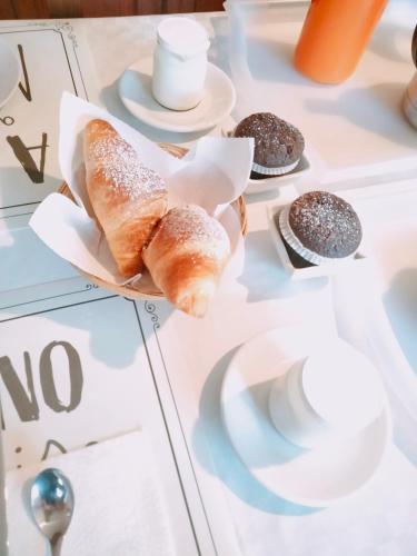 a table with croissants and other pastries on it at B&B Le Mi' Cocche in Capannori