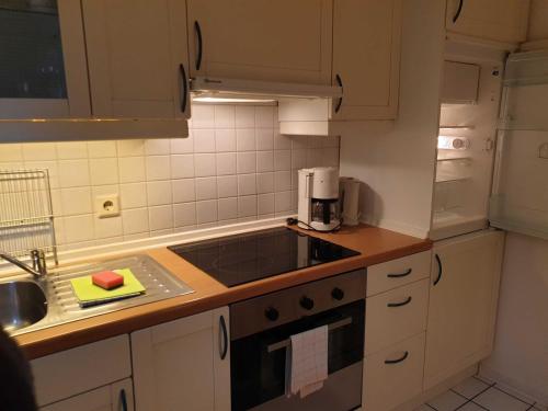 a kitchen with a sink and a stove top oven at Deichgräfin 4 in Horumersiel