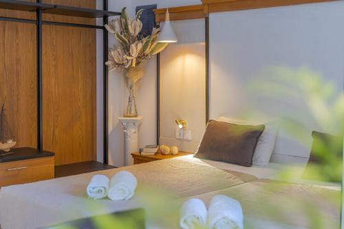 a bedroom with a bed with white towels on it at Camelot Royal Beds by Estia in Malia