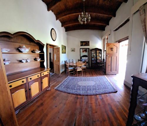 a living room with a table and a dining room at Goedgeloof Farm Stay in Barrydale