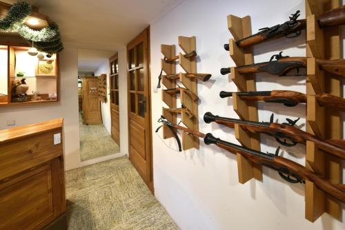 a hallway with a wall of wine racks on a wall at Vila Aurora - Vysoke Tatry in Mlynčeky