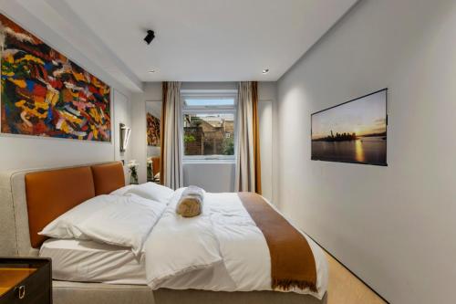 a bedroom with a large bed and a large window at Unique 1 Bedroom Luxury Haven In Central London in London