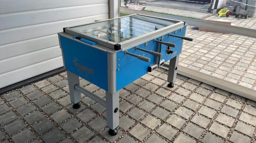 a blue table with a glass top on a sidewalk at Amelia Resort in Sianozety