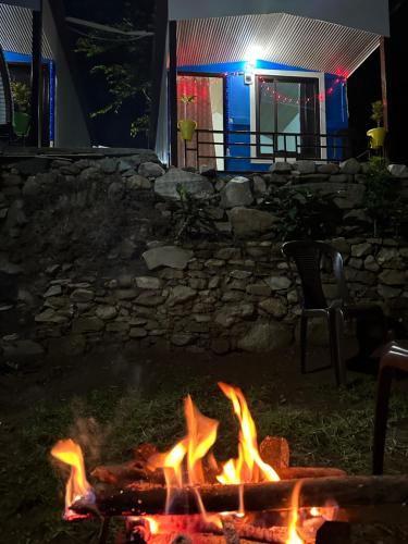 a fire pit in front of a house at night at Lake Haven Resort, Sari, Chopta in Sari