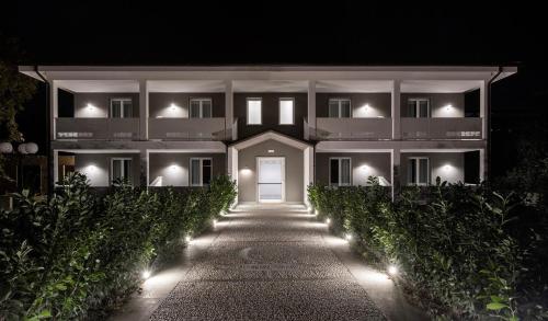 a white building with a white door at night at Loriana Park Hotel Sul Lago in Bolsena